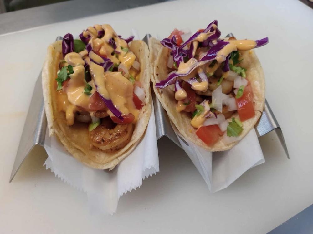 A plate of tacos served at Marco's Tacos with onion, cilantro, and lime