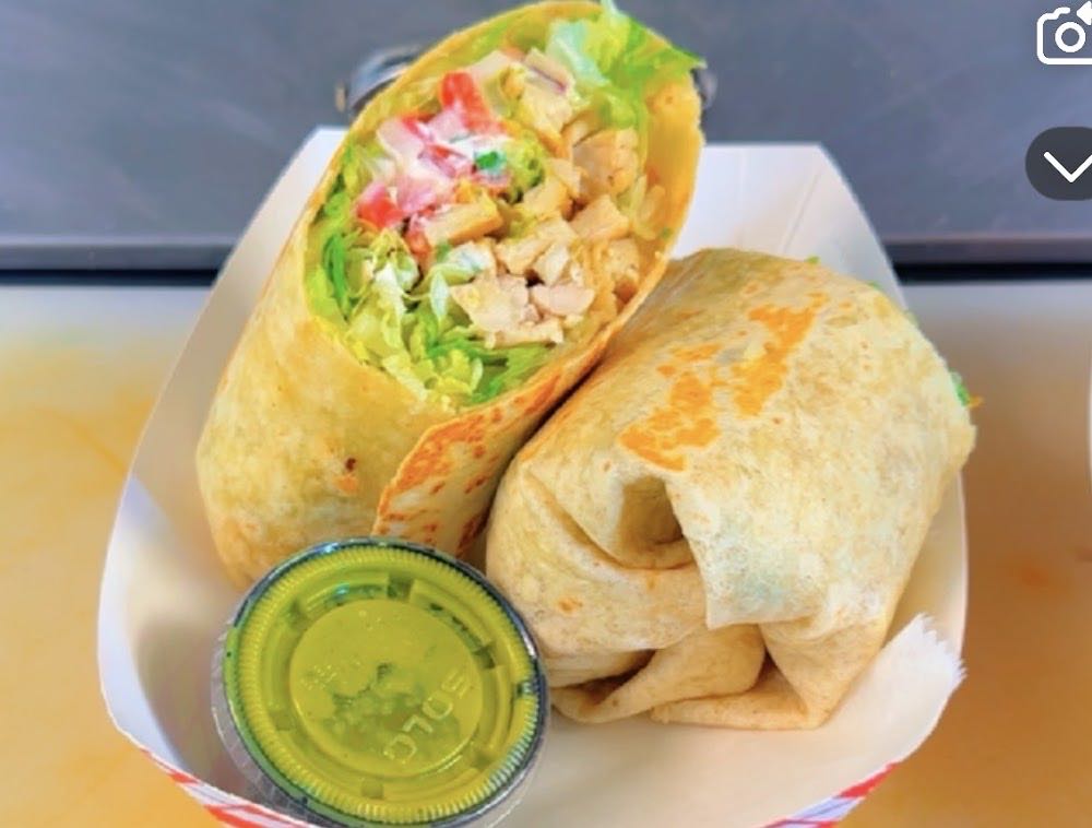 Inside the Marco's Tacos truck — meat cooking on the flat-top grill